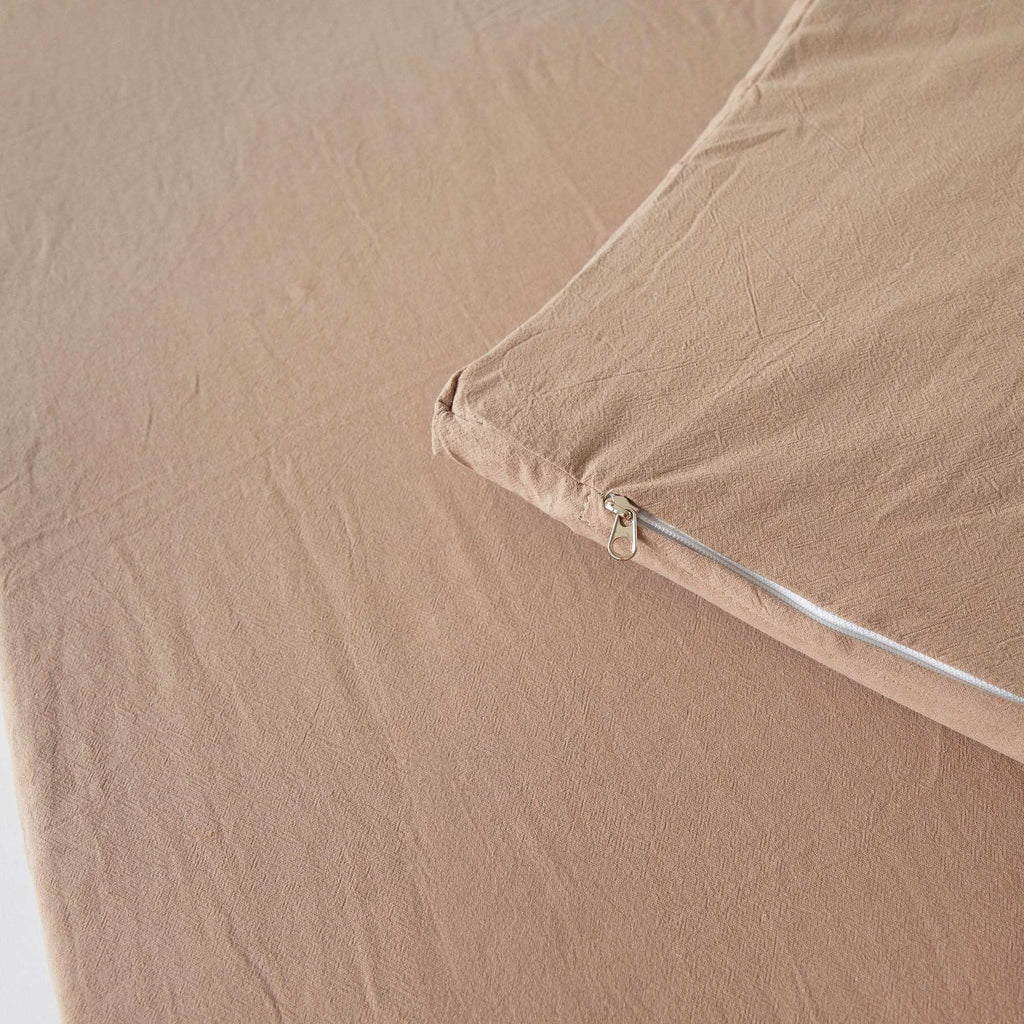 Zipper detail of the Chestnut Padded Play Mat, showing its removable, machine-washable cover.