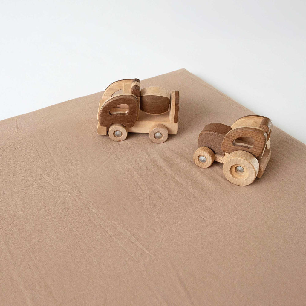 Chestnut Padded Play Mat with wooden toy trucks, perfect for playtime.