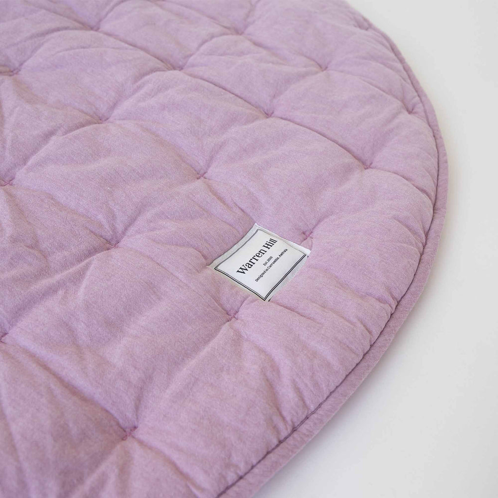 Soft, breathable cotton fabric with quilted stitching on the Lilac Quilted Play Mat.