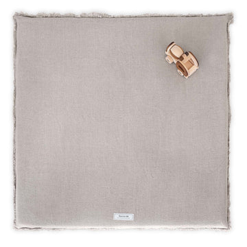 Linen Padded Play Mat – Raw Edge by Warren Hill laid flat with wooden toy trucks on top.