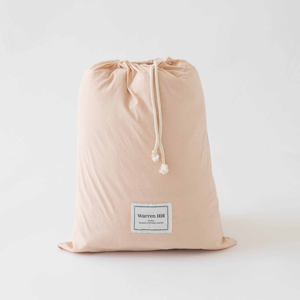 Peach Cotton Quilted Play Mat stored inside its matching drawstring dust bag for easy storage