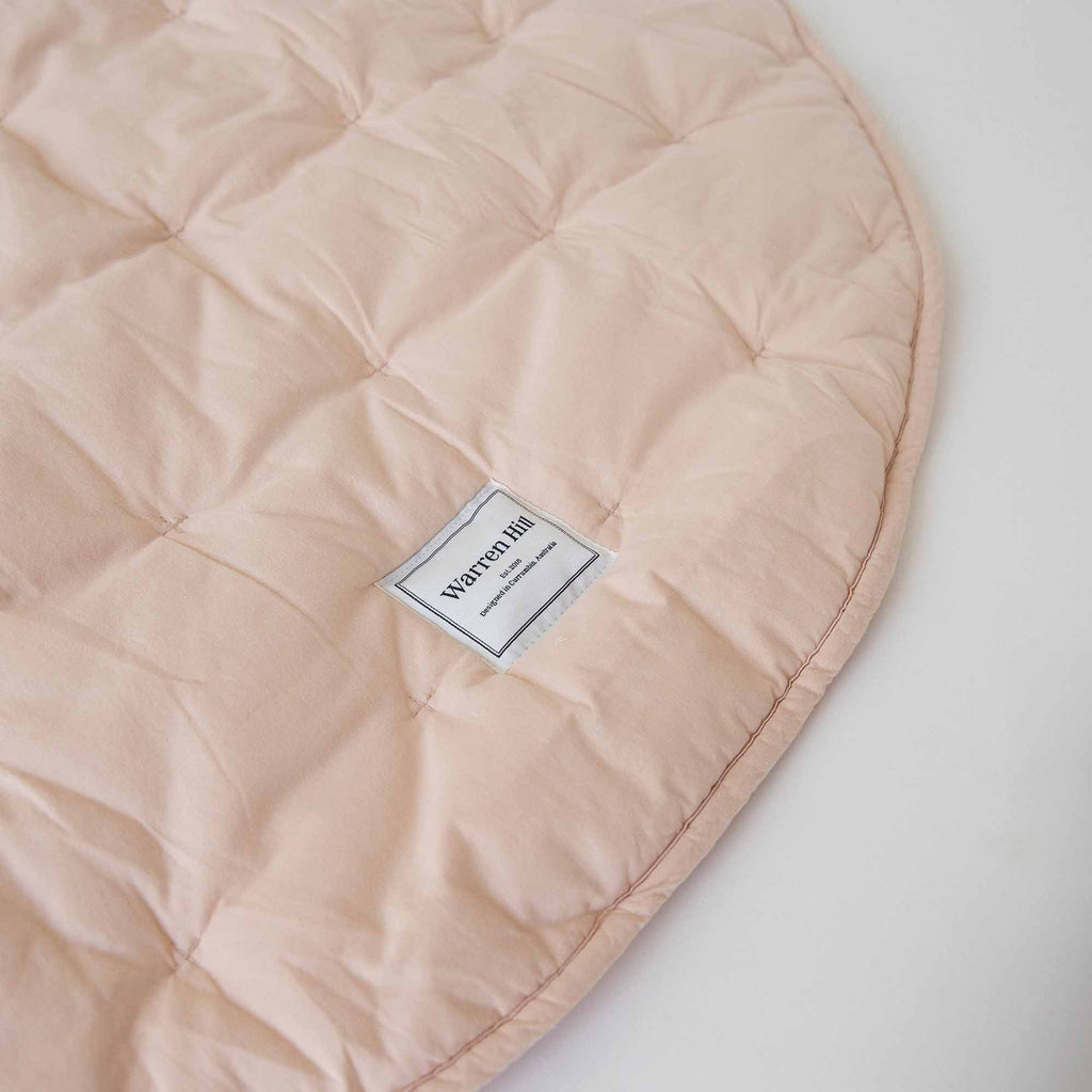 Soft, breathable cotton fabric with quilted stitching on the Peach Quilted Play Mat