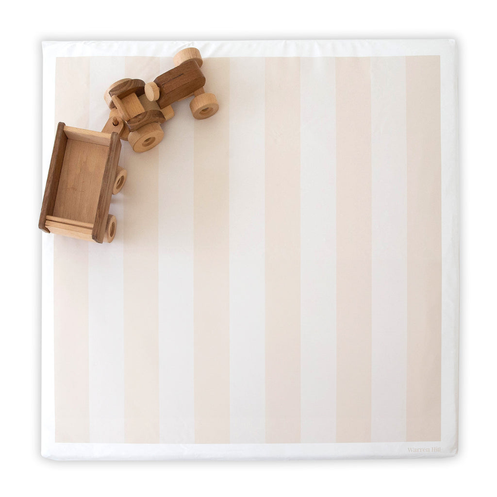 Wipeable Beige Padded Play Mat featuring a reversible striped design, styled with wooden toys.