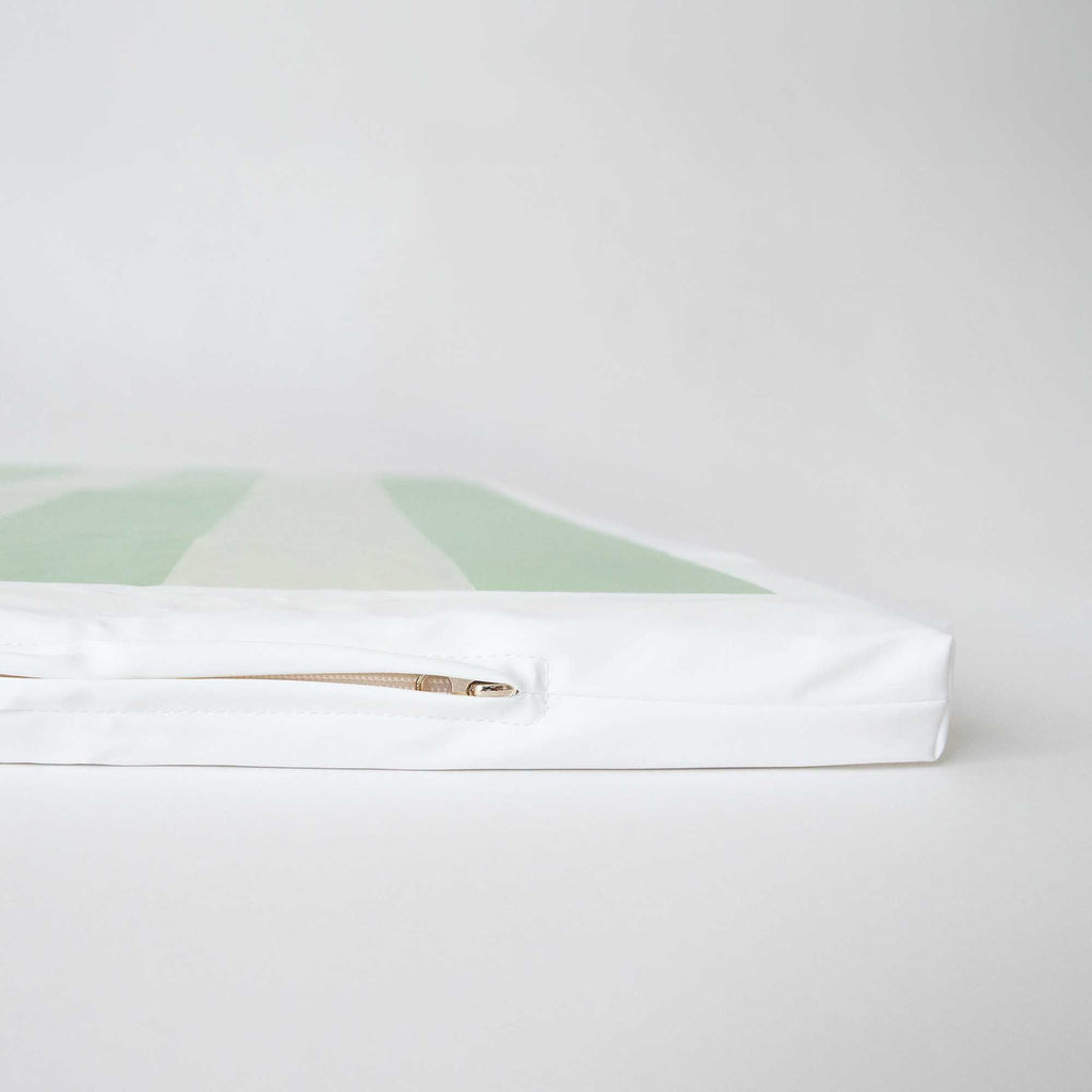 Side view of the Wipeable Green Padded Play Mat, showcasing its zippered, removable cover.