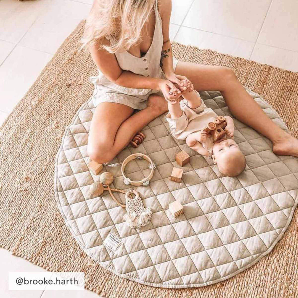 Thick, cushioned quilted linen play mat in Natural providing comfort for playtime