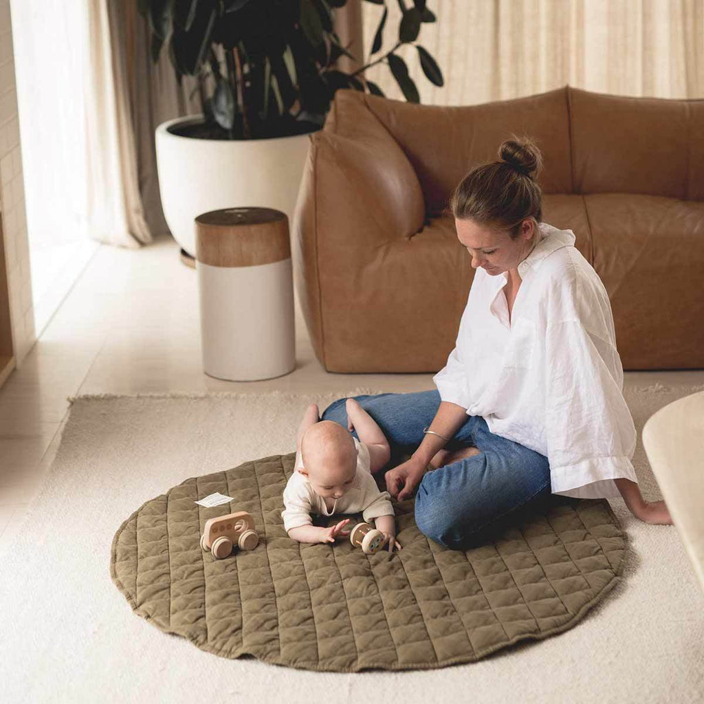 Mum and baby playing on an Olive Linen Baby Play Mat in a modern neutral home